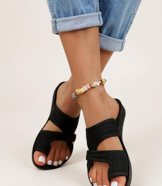Black textured criss cross slides with cushioned footbed and open toe design