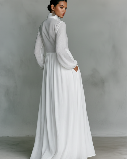 Back view of white maxi dress with long sleeves and flowing pleated skirt