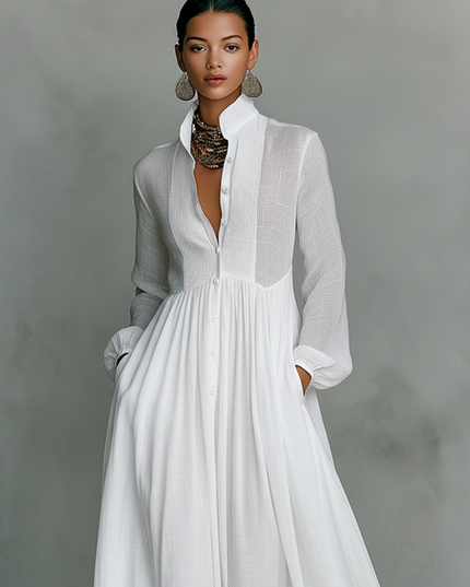 White maxi dress front detail showing stand collar, button closure, and pleated bodice