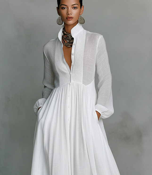White maxi dress front detail showing stand collar, button closure, and pleated bodice