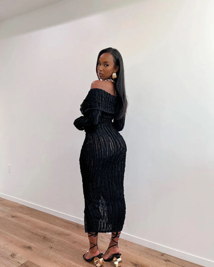 Black off shoulder midi dress with long sleeves, textured ribbed detail, and front slit