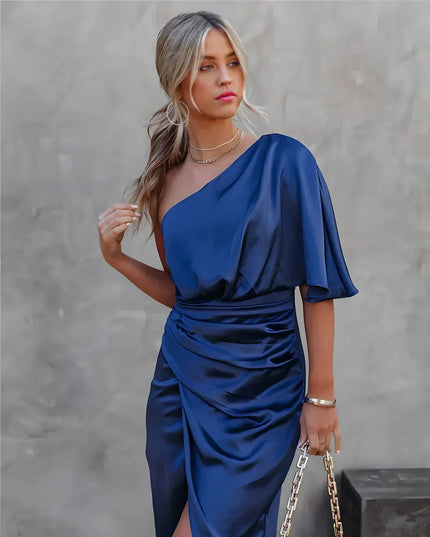 Women's navy blue one shoulder draped satin midi dress with a cinched waist and side slit