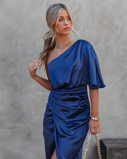 Women's navy blue one shoulder draped satin midi dress with a cinched waist and side slit