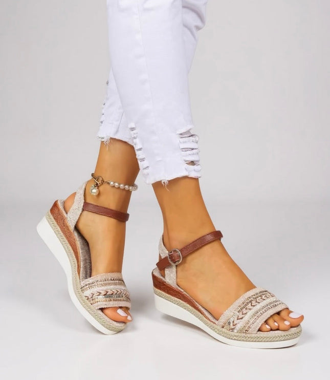 Beaded wedge sandals with adjustable brown ankle strap and textured cream footbed