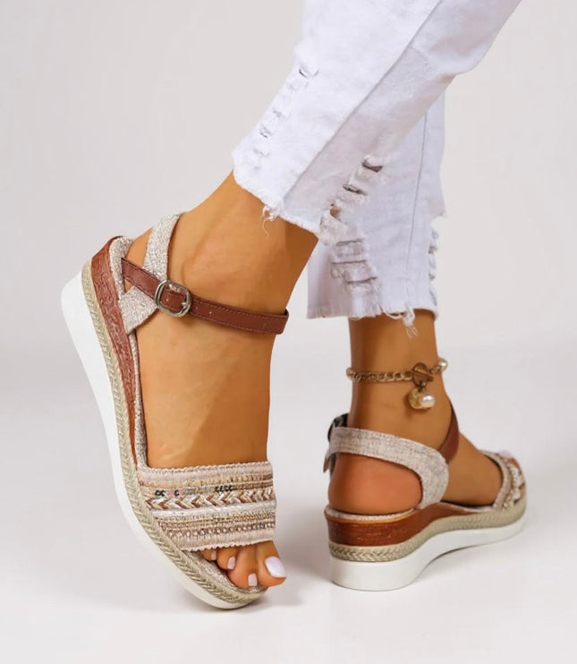 Tan beaded wedge sandals with brown ankle strap and white platform sole, side view