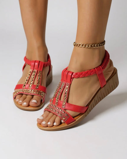 Red embellished wedge platform sandals with gold rhinestone details and braided straps