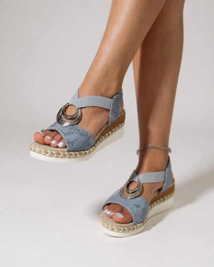 Blue textured platform espadrille sandals with metal ring detail worn on feet