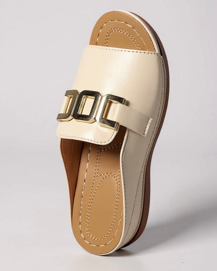 Cream platform slide mule with gold buckle, bottom sole detail