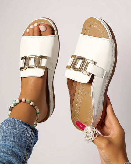 Top and side view of white leather platform mules with chunky gold buckle