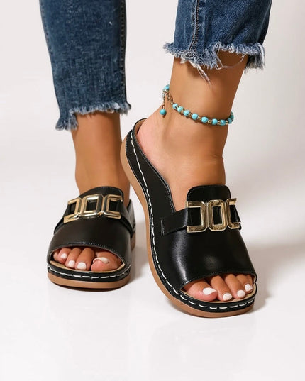 Black platform slide mules with gold buckle and white contrast stitching