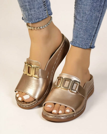 Champagne metallic slide mules with gold buckle, front angle