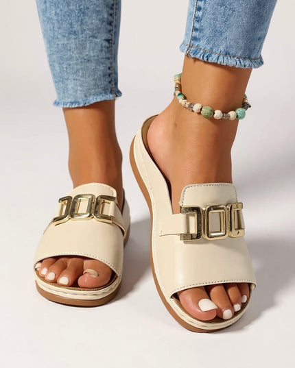 Cream platform mule with gold buckle, overhead sole view