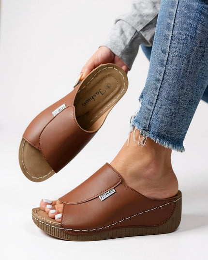 Cognac brown platform slide with white stitching and cushioned footbed