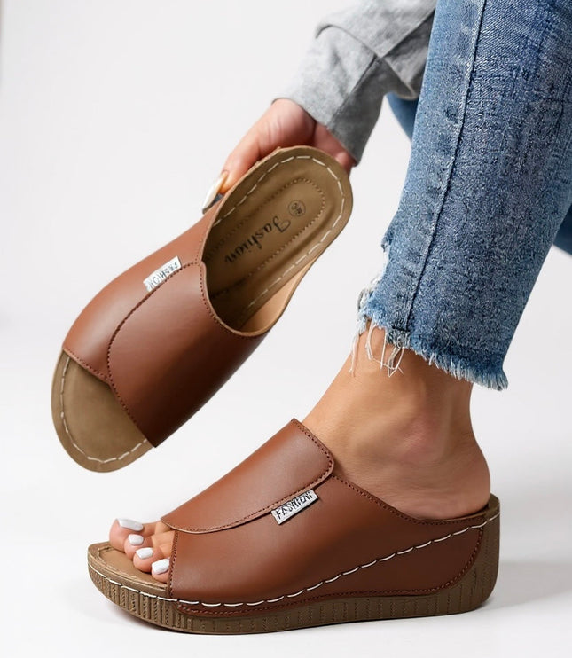 Cognac brown platform slide with white stitching and cushioned footbed