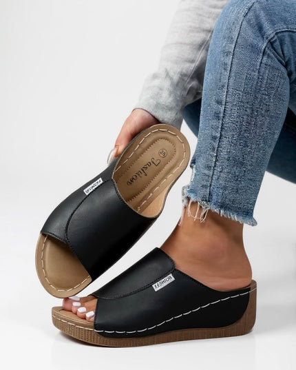 Black platform mule showing contoured footbed detail and stitching