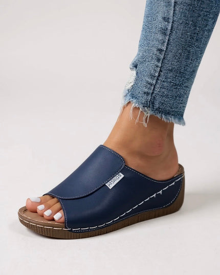 Navy blue platform slide with white stitching and cushioned footbed