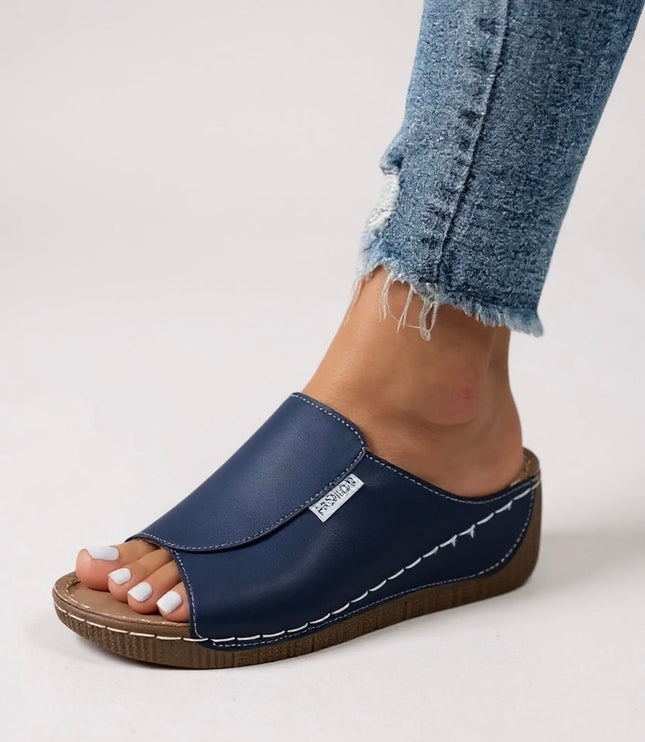 Navy blue platform slide with white stitching and cushioned footbed