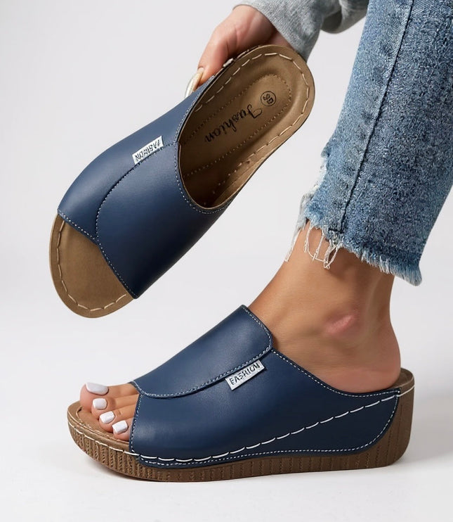 Navy leather platform sandal with contoured support and tan base