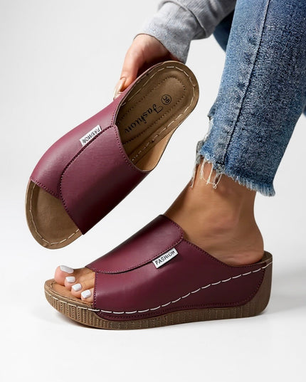 Burgundy platform slide with white topstitching and molded footbed