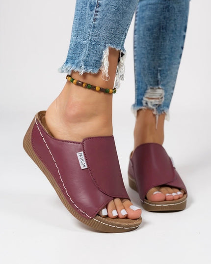 Burgundy platform mule worn with beaded ankle bracelet detail