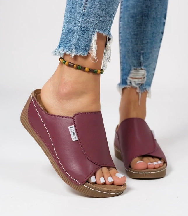 Burgundy platform mule worn with beaded ankle bracelet detail