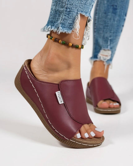 Burgundy leather platform slide with contoured footbed side view