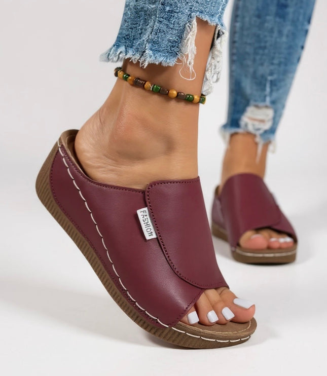 Burgundy leather platform slide with contoured footbed side view