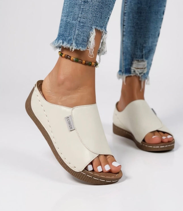 Cream white platform slide with tan sole and contoured support