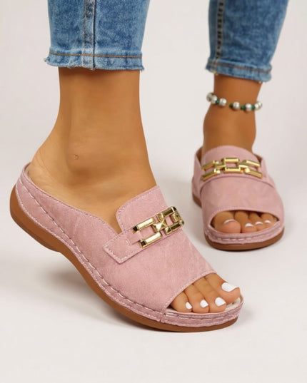 Pink suede slide sandal with gold chain detail and cushioned platform sole