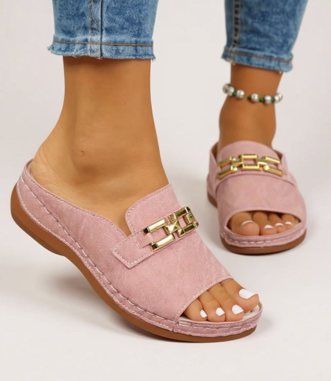 Pink suede slide sandal with gold chain detail and cushioned platform sole