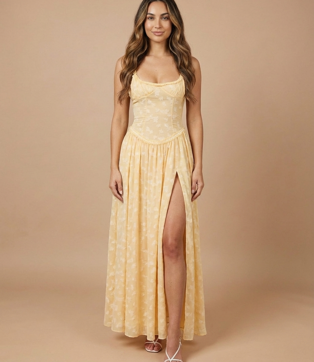 Front view of pale yellow summer floral maxi dress with sheer bodice and flowing skirt