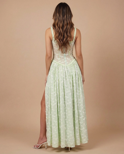 Rear view of light green summer dress showing open back, floral mesh bodice, and long skirt