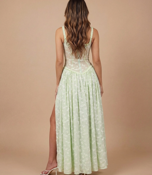 Rear view of light green summer dress showing open back, floral mesh bodice, and long skirt