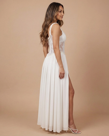 White floral maxi dress with sheer corset bodice, spaghetti straps, and front slit