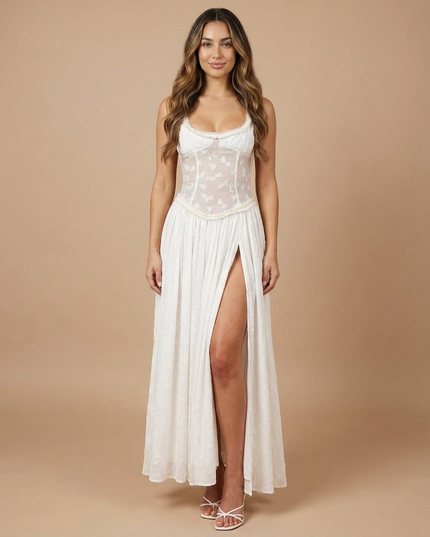 Side view of white summer floral maxi dress with sheer back panel and flowing skirt