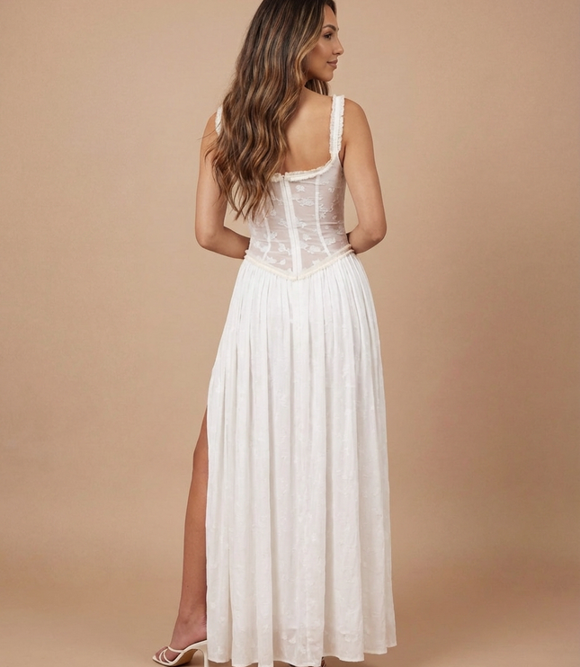 Front view of white floral maxi dress with fitted sheer bodice and thigh-high slit