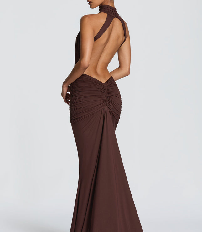 Rear three-quarter view of brown halter maxi dress with open back and ruched skirt