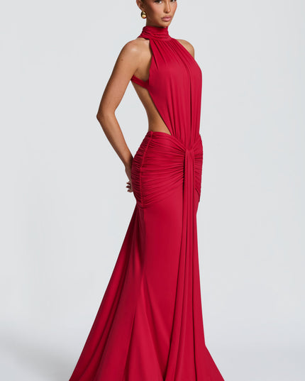 Side view of red halter cutout ruched maxi dress with fitted skirt