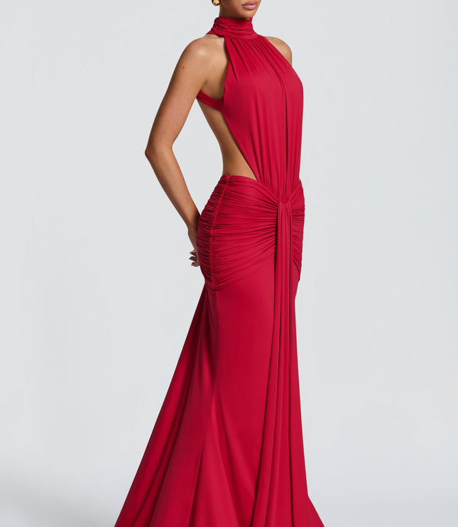 Side view of red halter cutout ruched maxi dress with fitted skirt