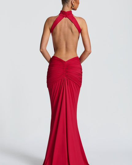 Back view of red halter maxi dress showing open back and ruched skirt