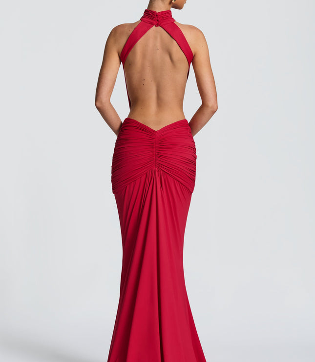 Back view of red halter maxi dress showing open back and ruched skirt