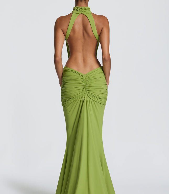 Back view of green maxi dress with open back, halter straps, and ruched skirt detail