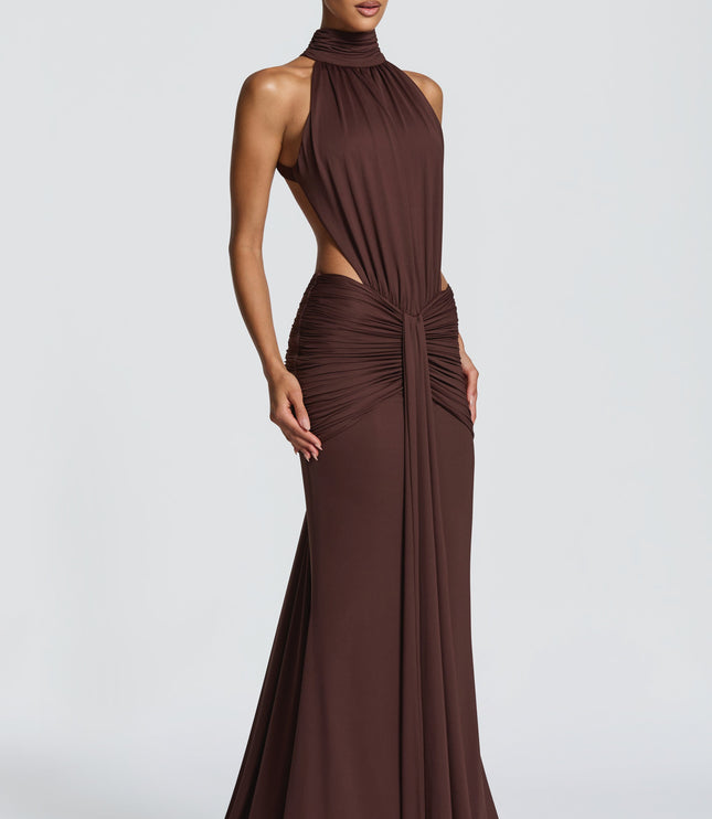 Three-quarter view of brown ruched maxi dress with high halter neckline and open sides