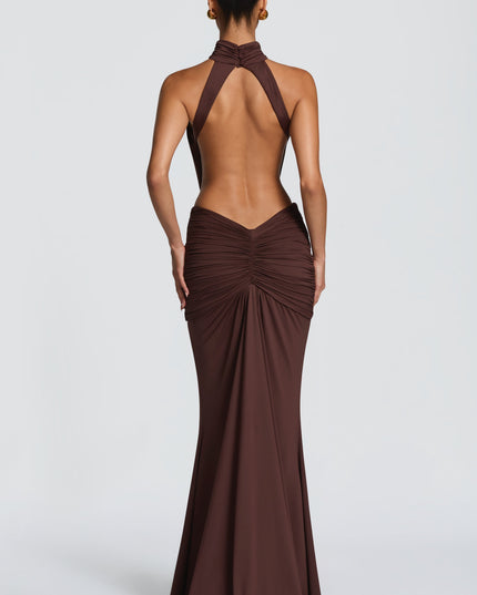 Back view of brown halter cutout maxi dress with open back and gathered skirt