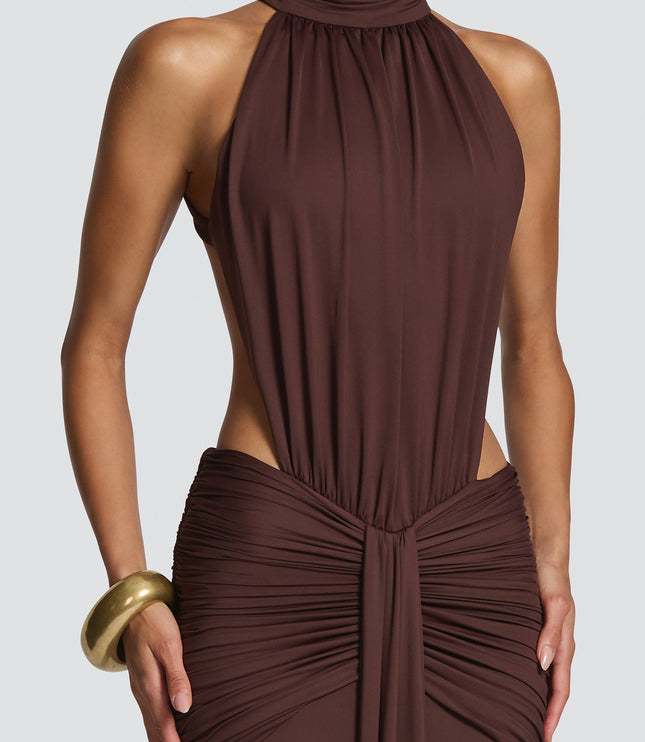 Side view of brown ruched maxi dress with halter top and fitted waist detail
