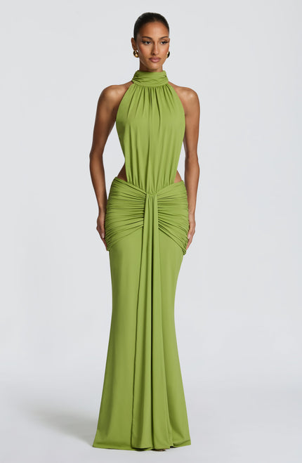 Front view of green halter maxi dress with ruched waist and side cutouts