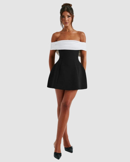 Front view of black and white off-shoulder mini dress with pleated skirt