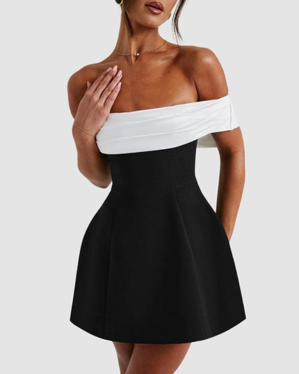 Close-up of off-shoulder white wrap neckline on black mini dress with A-line skirt