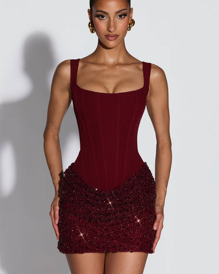 Front view of burgundy sequin party dress with fitted square neck top and sparkly skirt