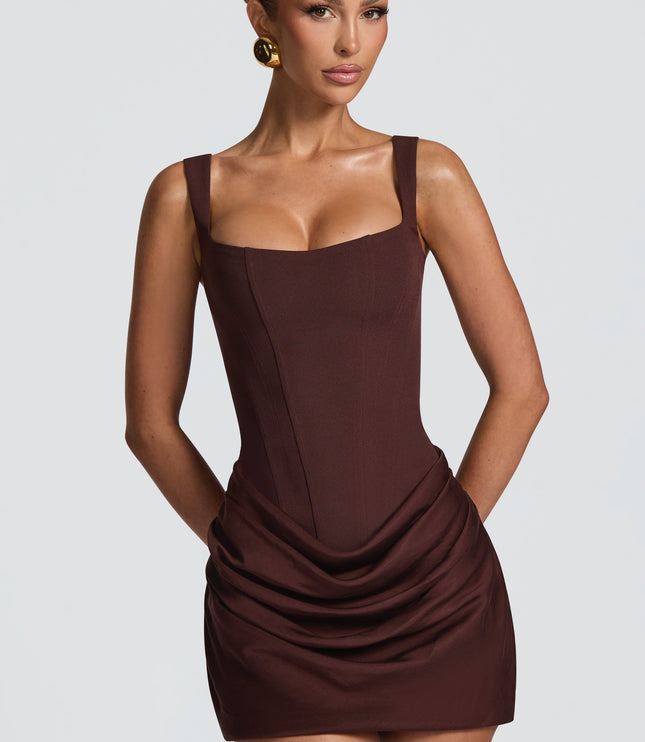 Front view of a women's party mini dress in dark brown with a square neck and structured bodice, featuring subtle draping on the skirt.
